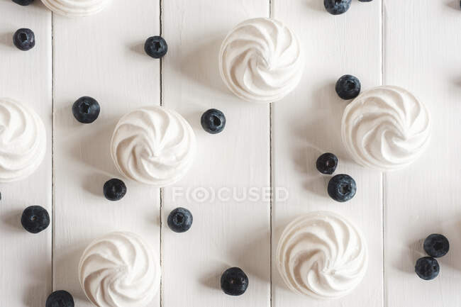 White meringue cream with whipped creams on a wooden background. top view. — Stock Photo