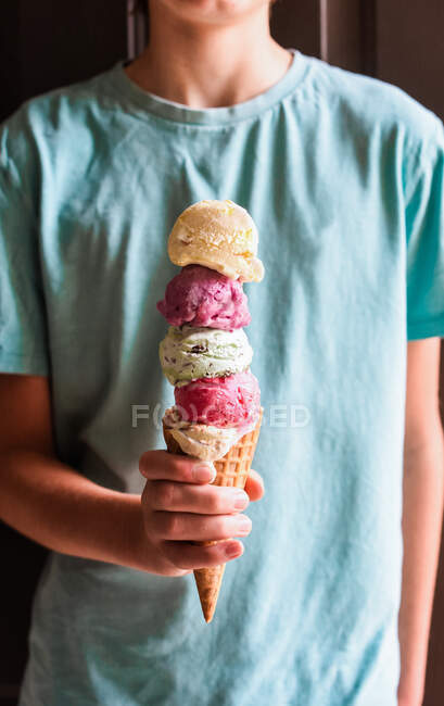 Criança com sorvete em cone no fundo, close-up — Fotografia de Stock