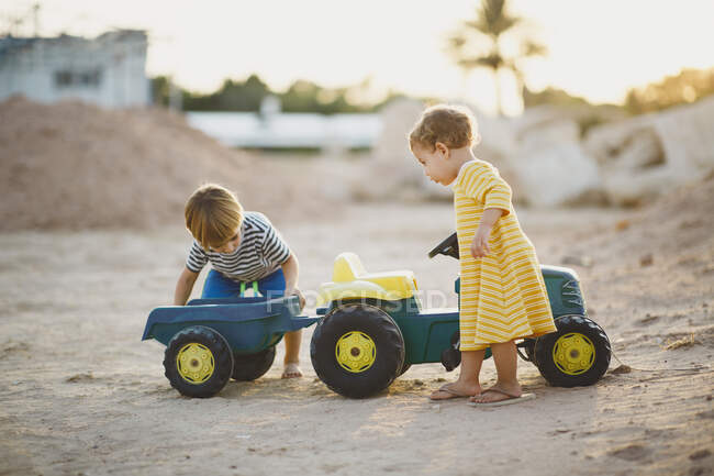 Kinder spielen gemeinsam mit Spielzeugtraktor — Stockfoto
