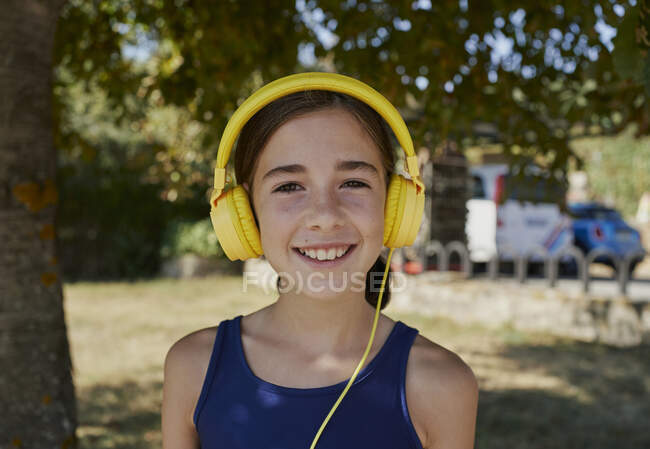 Close-up of a girl who smiles and looks to the camera — Stock Photo