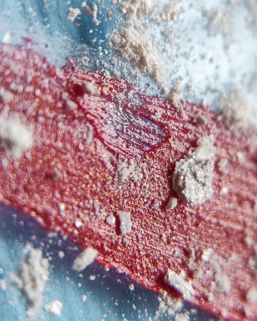 Close-up of lipsticks for lips on top of scattered shadows — Stock Photo