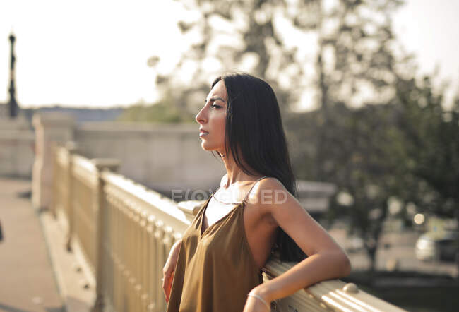 Portrait of young woman on a bridge — Stock Photo