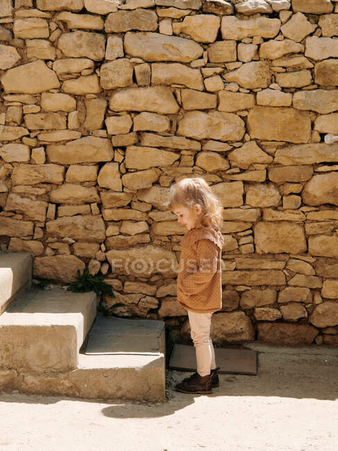 Cute girl stands in front of the stairs. the first step into adulthood — Stock Photo