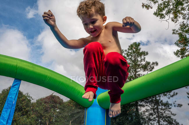 Мальчик прыгает на детской площадке — стоковое фото