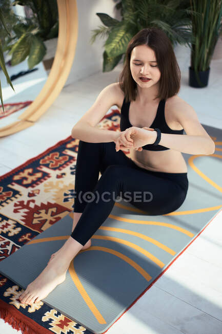 Beautiful young woman doing yoga exercises at home — Stock Photo