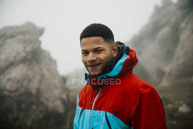 Close-up of young latin boy looking at camera during a foggy day — Stock Photo