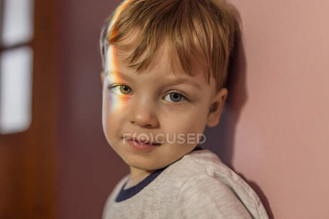 Portrait of a toddler boy with rainbow light on his right eye — Stock Photo