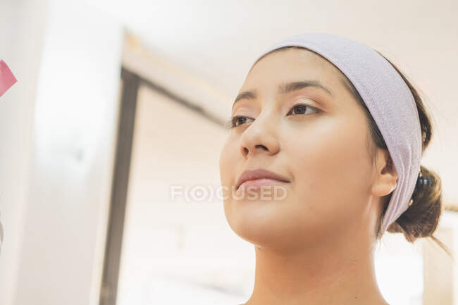 Young woman getting ready to put on makeup for a special event. In a makeup center enjoying this day. — Stock Photo