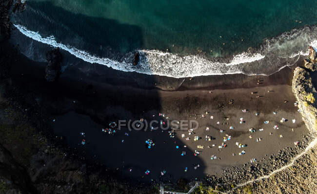 Aerial top view on a sandy beach and a cliff. — Stock Photo