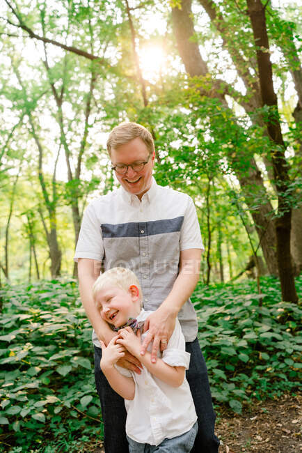 Closeup portrait of a father and son together in the forest — Stock Photo