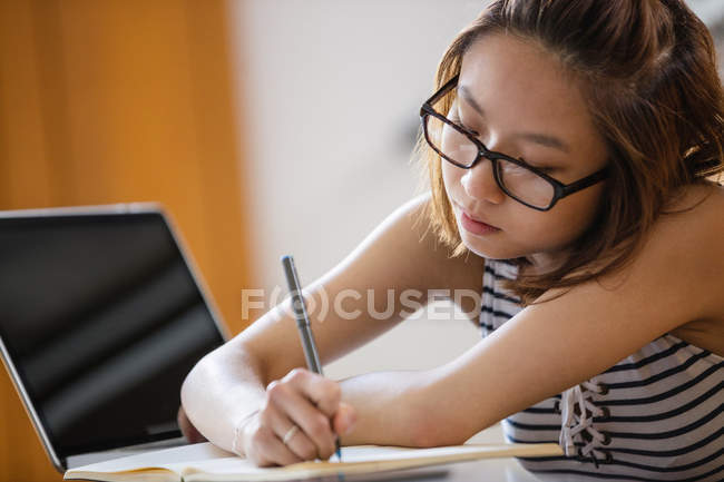 Young woman studying in classroom — Stock Photo