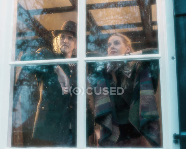 Pensive musicians behind rainy window — Stock Photo