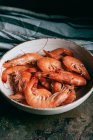 Close up image of shrimps on plate and kitchen towel on table — Stock Photo