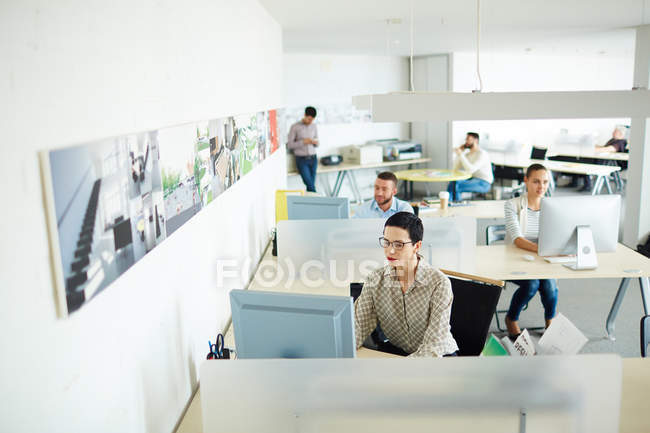 Contemporary businesswoman computing by her workplace — Stock Photo