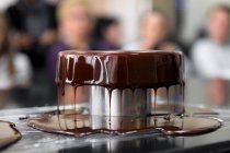 Gâteau au chocolat avec glaçure goutte à goutte présenté sur stand — Photo de stock