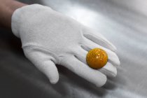 Close-up view of confectioner hand holding candy — Stock Photo