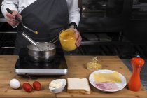 Vista ritagliata di cuoco maschio che fa salsa al curry — Foto stock