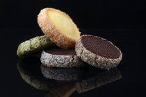 Divers biscuits avec glaçage au sucre sur fond noir — Photo de stock