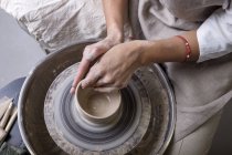 Close-up view of female potter hands making pot — Stock Photo