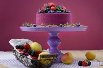 Cake on stand with fresh berries and fruits — Stock Photo