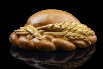 Braided bread loaf with wheat ears decoration — Stock Photo