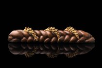 Braided bread loaf on black background — Stock Photo