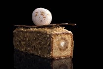 Cake with caramel filling, chocolate glaze and macaron decoration — Stock Photo