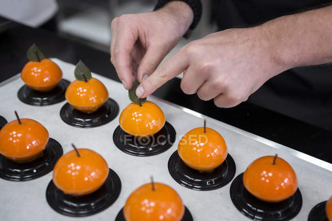 Close-up view of confectioner making fruit-shaped cakes — Stock Photo