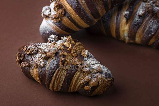 Croissants with striped pattern and nuts on table — Stock Photo