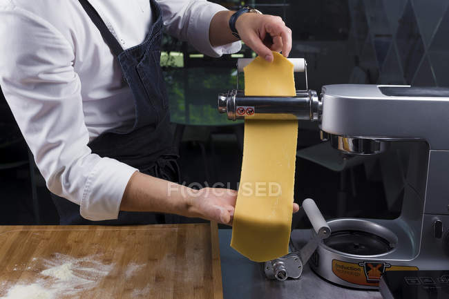 Cropped view of male chef making pasta — Stock Photo