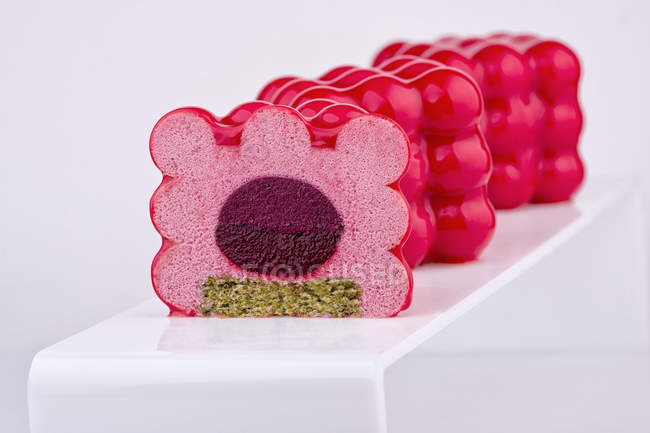 Mousse cakes with jam filling on white background — Stock Photo