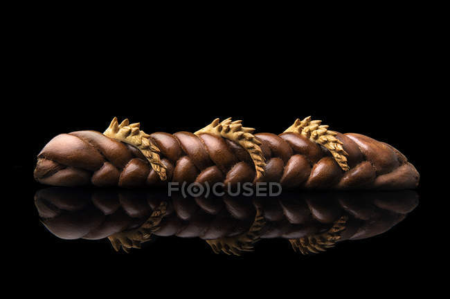 Braided bread loaf on black background — Stock Photo