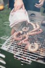 Preparing squid on grill outdoors, close up view — Stock Photo