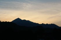 Silhouette of mountain over pastel sky — Stock Photo