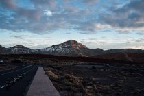 Panorama of road at mountain valley and serene cloudscape — Stock Photo