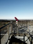 Telescopio rosso sul ponte del cielo sullo sfondo di campi di campagna e cielo limpido — Foto stock