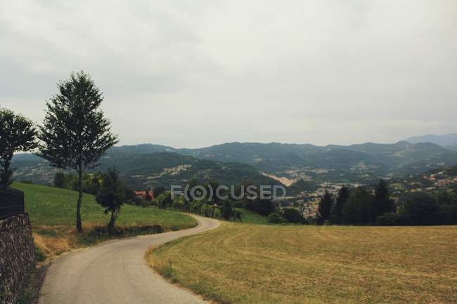 Idyllic view to curvy rural road at countryside — Stock Photo