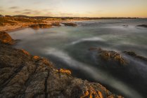 Long exposure at rocky shore at Asilomar State Beach, Monterey County, California, USA — Stock Photo