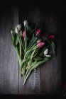 Freshly cut tulips on wooden background — Stock Photo