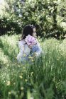 Girl holding bunch of pink peonies in countryside garden. — Stock Photo