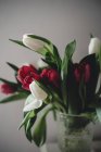 Close-up of bunch of tulips in vase — Stock Photo