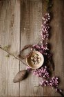 Easter decoration with quail eggs in clay bowl and tree blossom — Stock Photo