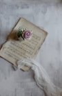 Pink rose on table with sheet music — Stock Photo
