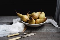 Still life with pears with vintage cutlery on rustic table — Stock Photo