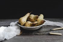 Still life with pears with vintage cutlery on rustic table — Stock Photo