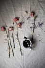 Tasse Kaffee mit Vintage-Löffel und Rosenblüten und Blütenblättern auf dem Tisch, Draufsicht — Stockfoto