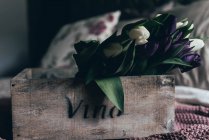 White and purple tulips in vintage wooden crate — Stock Photo