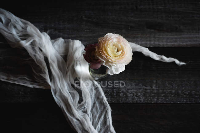 Pastel ranunculus flowers on rustic table, top view — Stock Photo