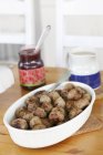 Bowl of cooked meatballs with sauce on table — Stock Photo