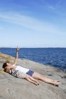 Mother with son lying down on seaside, selective focus — Stock Photo